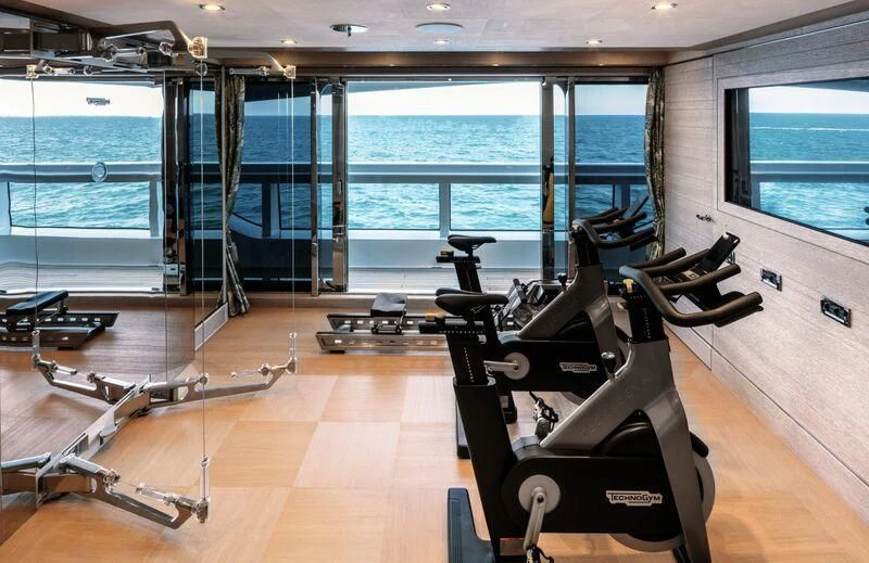 a gym with a large window aboard STARBURST IV Yacht for Charter