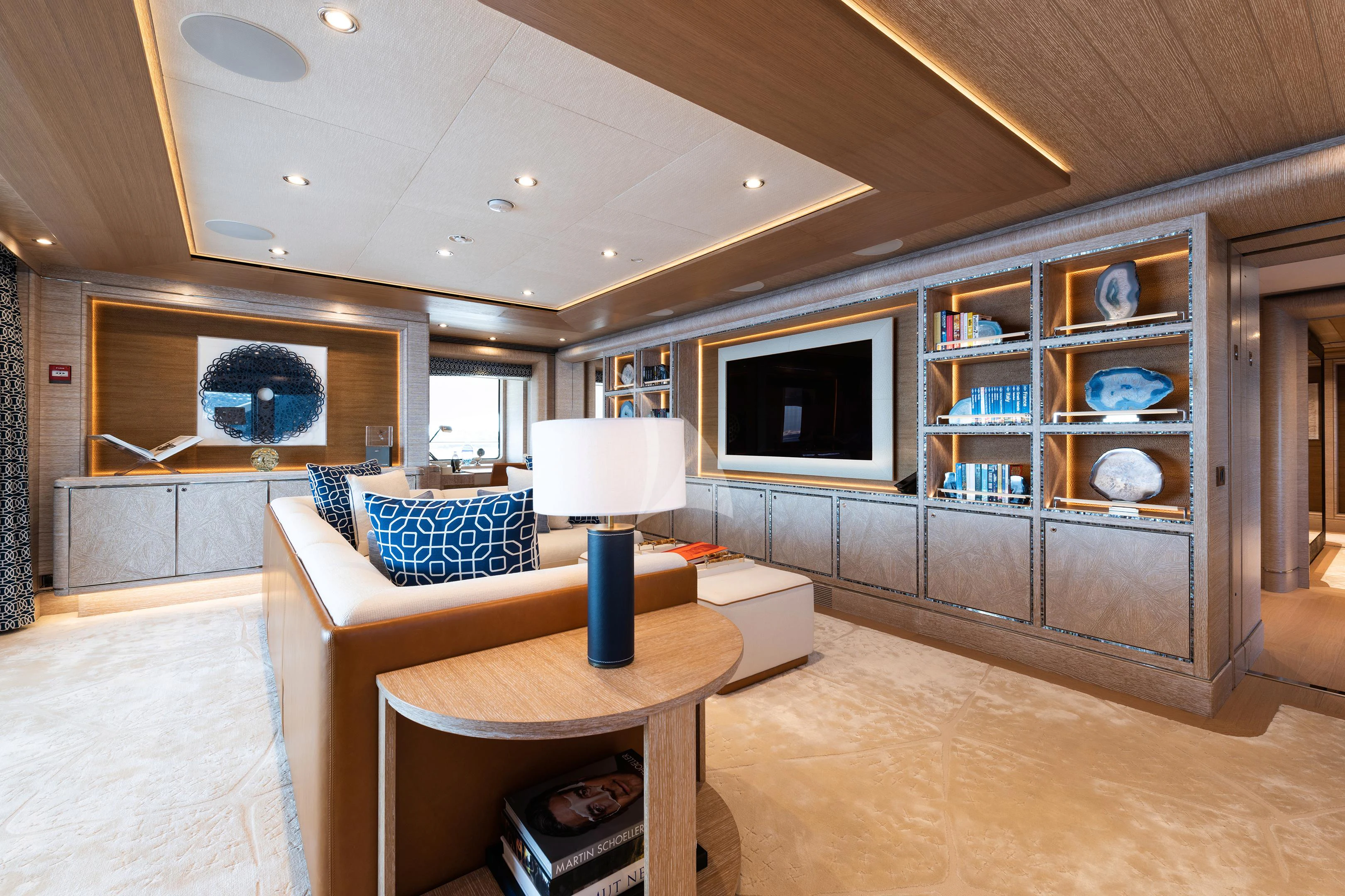 a living room with a table and a tv aboard STARBURST IV Yacht for Charter