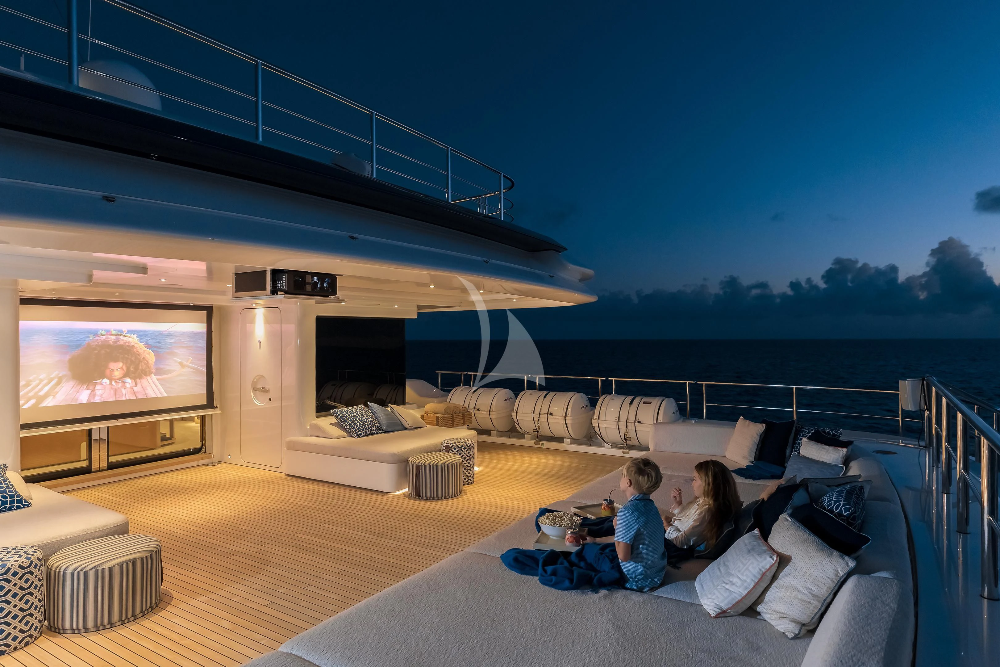 a couple of people watching a television aboard STARBURST IV Yacht for Charter