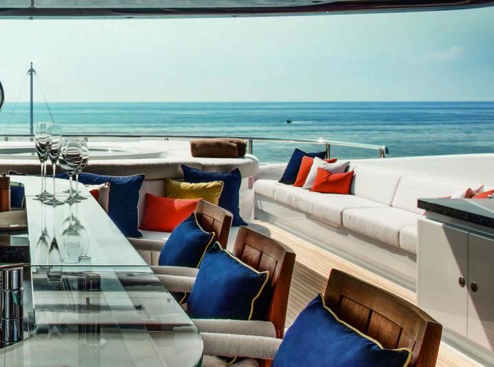 a room with a bed and a table with chairs aboard STARBURST IV Yacht for Charter
