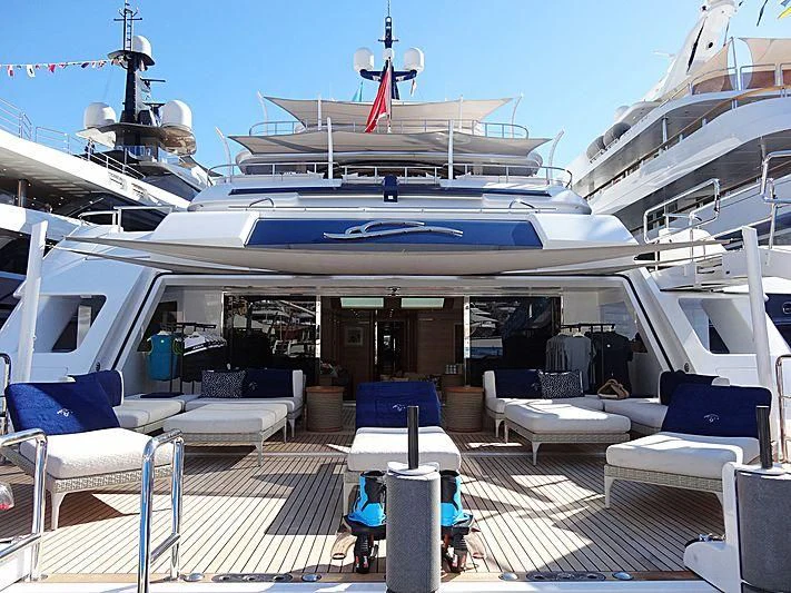a cruise ship with a deck and chairs and a couple of people sitting on the deck aboard STARBURST IV Yacht for Charter