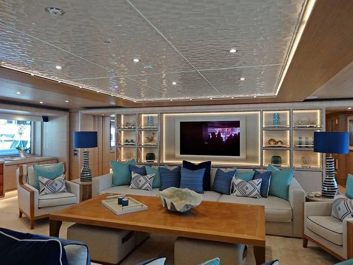a living room with a large screen aboard STARBURST IV Yacht for Charter