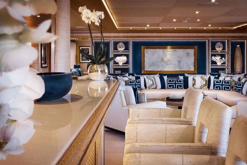 a living room with a large white sofa and a vase with flowers aboard STARBURST IV Yacht for Charter