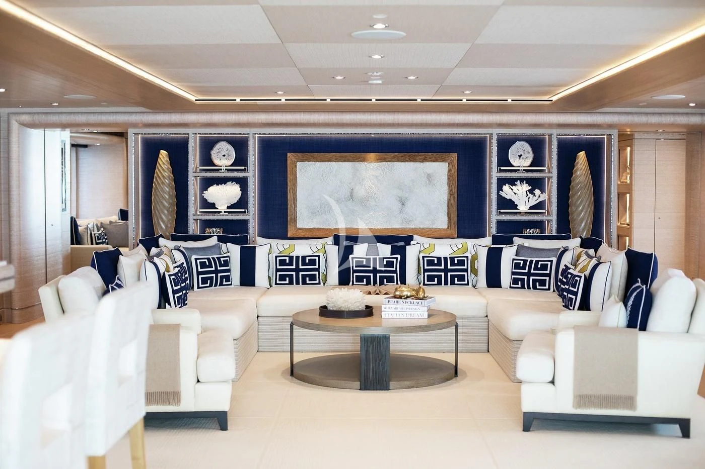 a room with white couches and a table aboard STARBURST IV Yacht for Charter