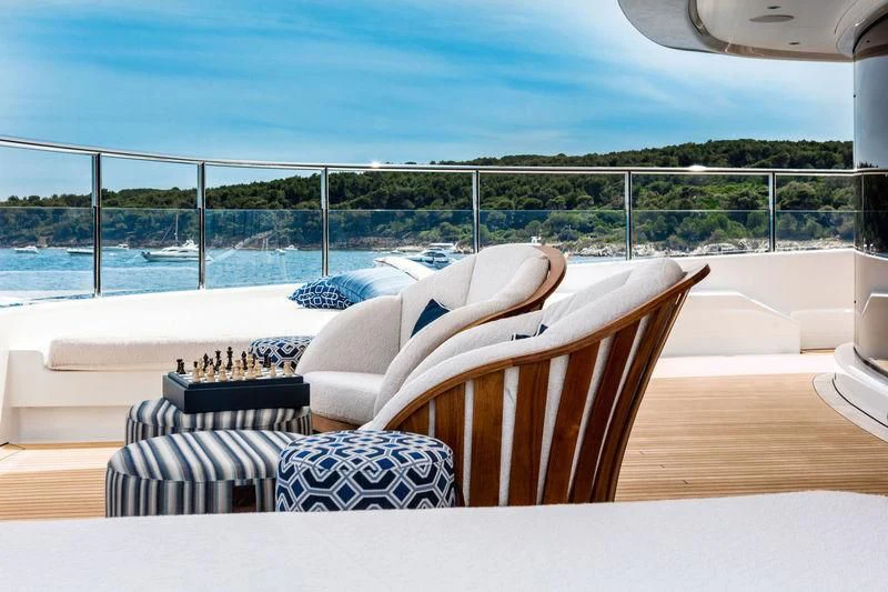 a room with a couch and a table and chairs aboard STARBURST IV Yacht for Charter