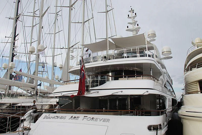 a boat with a flag on the front aboard DIAMONDS ARE FOREVER Yacht for Sale