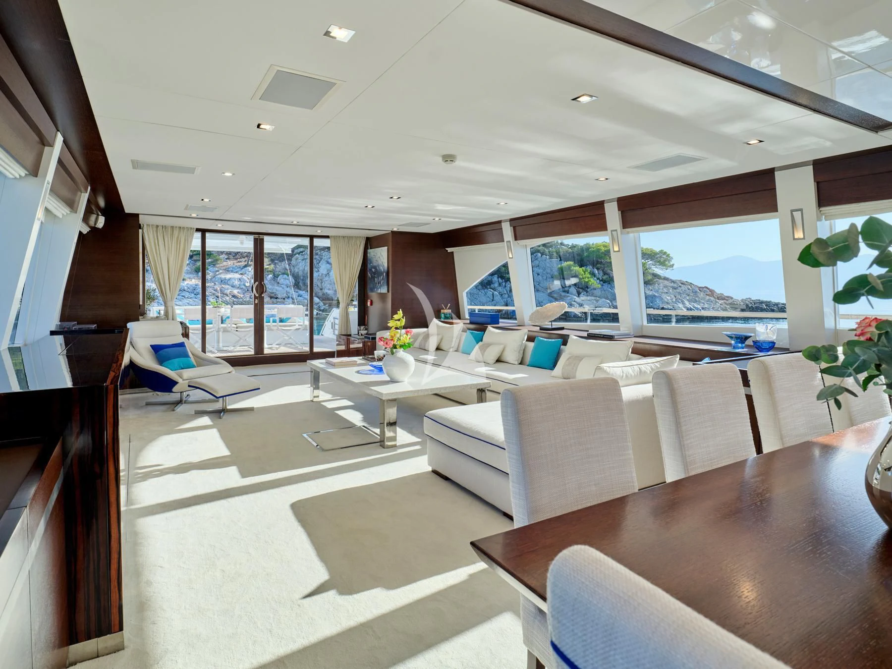 a room with a table chairs and a window aboard HAKUNA MATATA Yacht for Charter