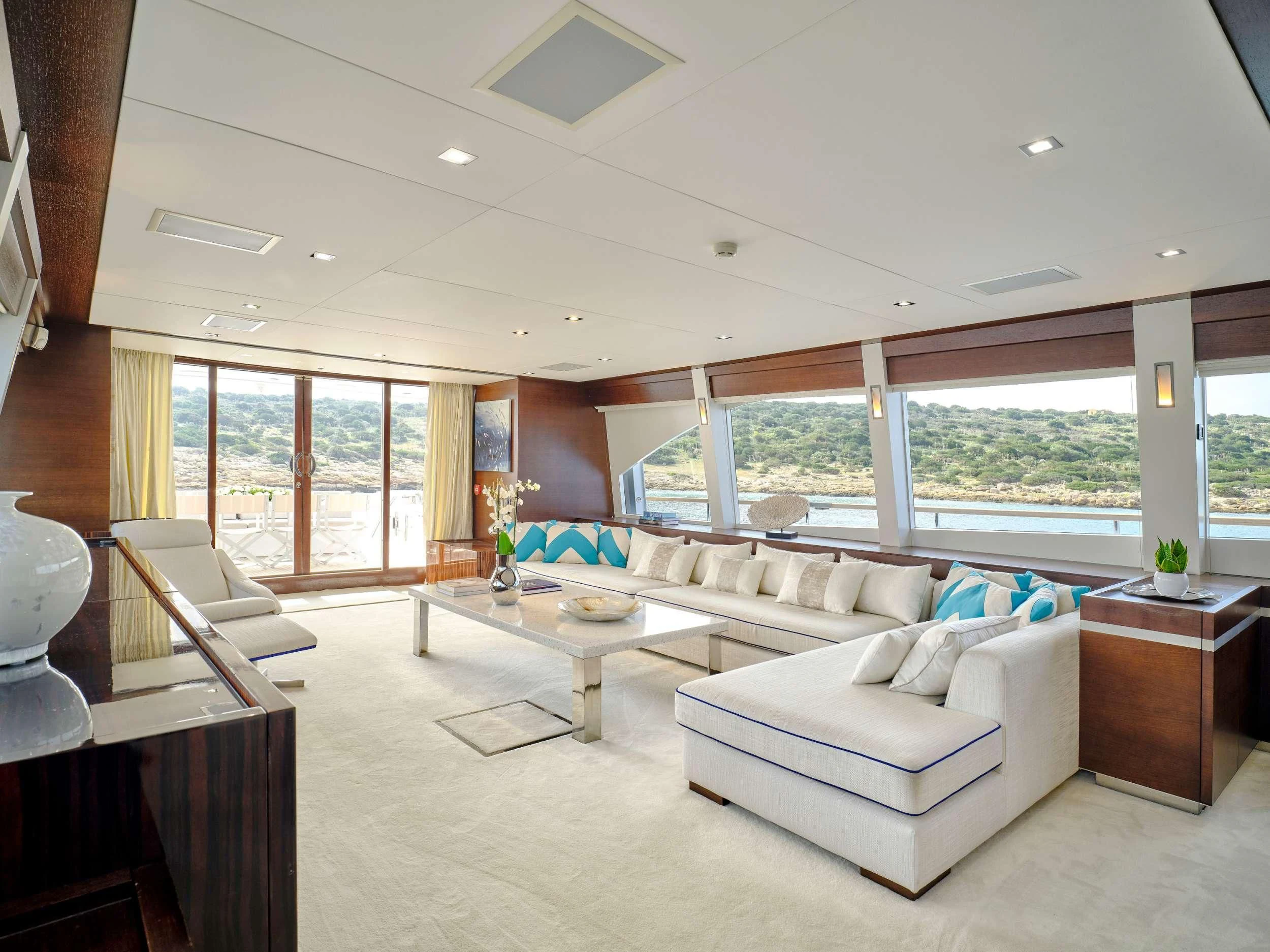 a living room with a large window aboard HAKUNA MATATA Yacht for Charter
