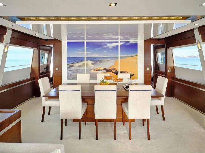 a room with a table and chairs aboard HAKUNA MATATA Yacht for Charter