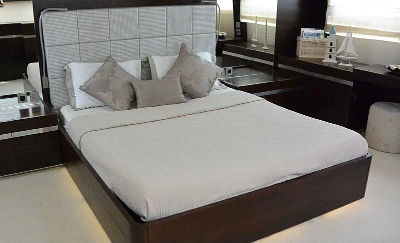 a bed with white sheets aboard HAKUNA MATATA Yacht for Charter