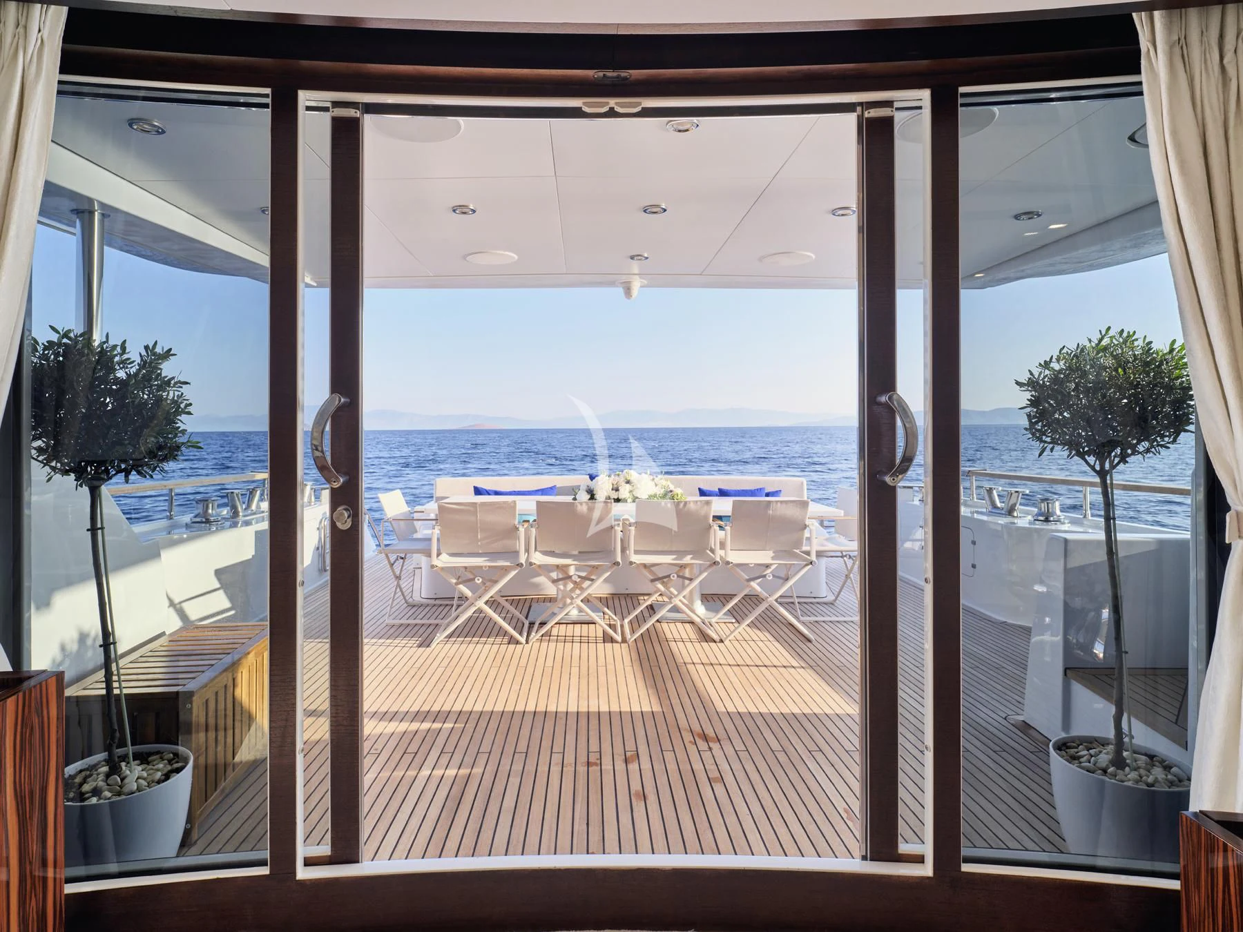 a room with a view of the ocean and the deck aboard HAKUNA MATATA Yacht for Charter