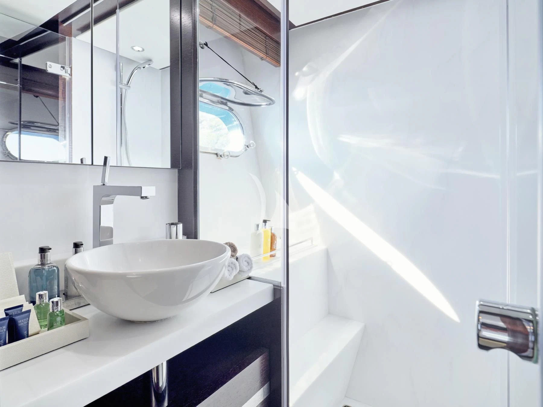 a bathroom with a sink and a mirror aboard HAKUNA MATATA Yacht for Charter