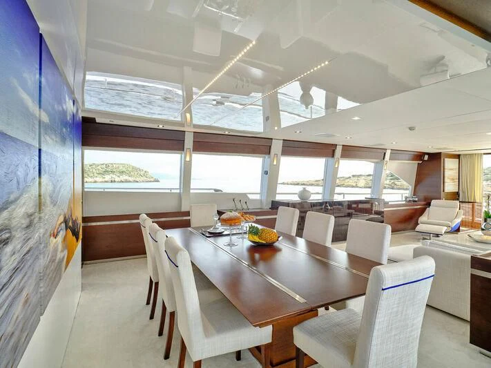 a room with tables and chairs aboard HAKUNA MATATA Yacht for Charter