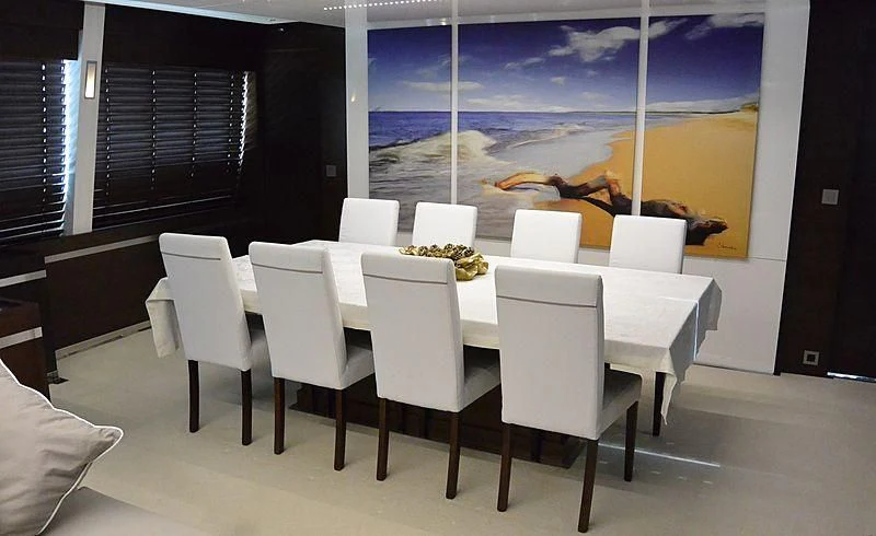 a room with tables and chairs aboard HAKUNA MATATA Yacht for Charter