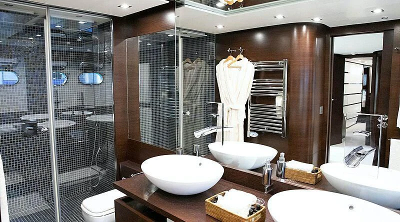 a bathroom with a large mirror aboard HAKUNA MATATA Yacht for Charter