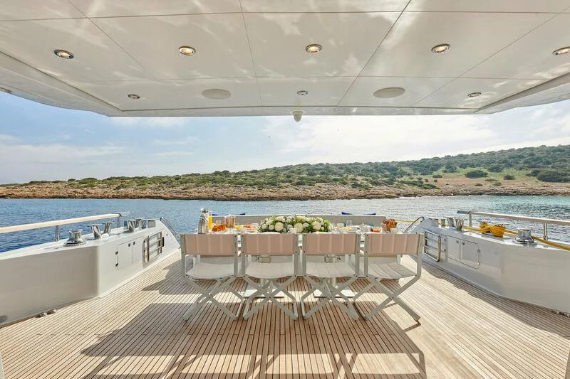 a room with a table and chairs aboard HAKUNA MATATA Yacht for Charter