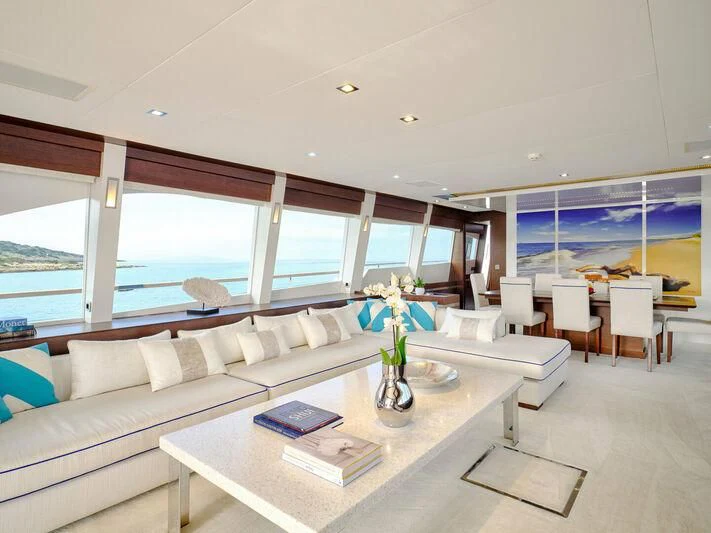 a living room with a large window aboard HAKUNA MATATA Yacht for Charter