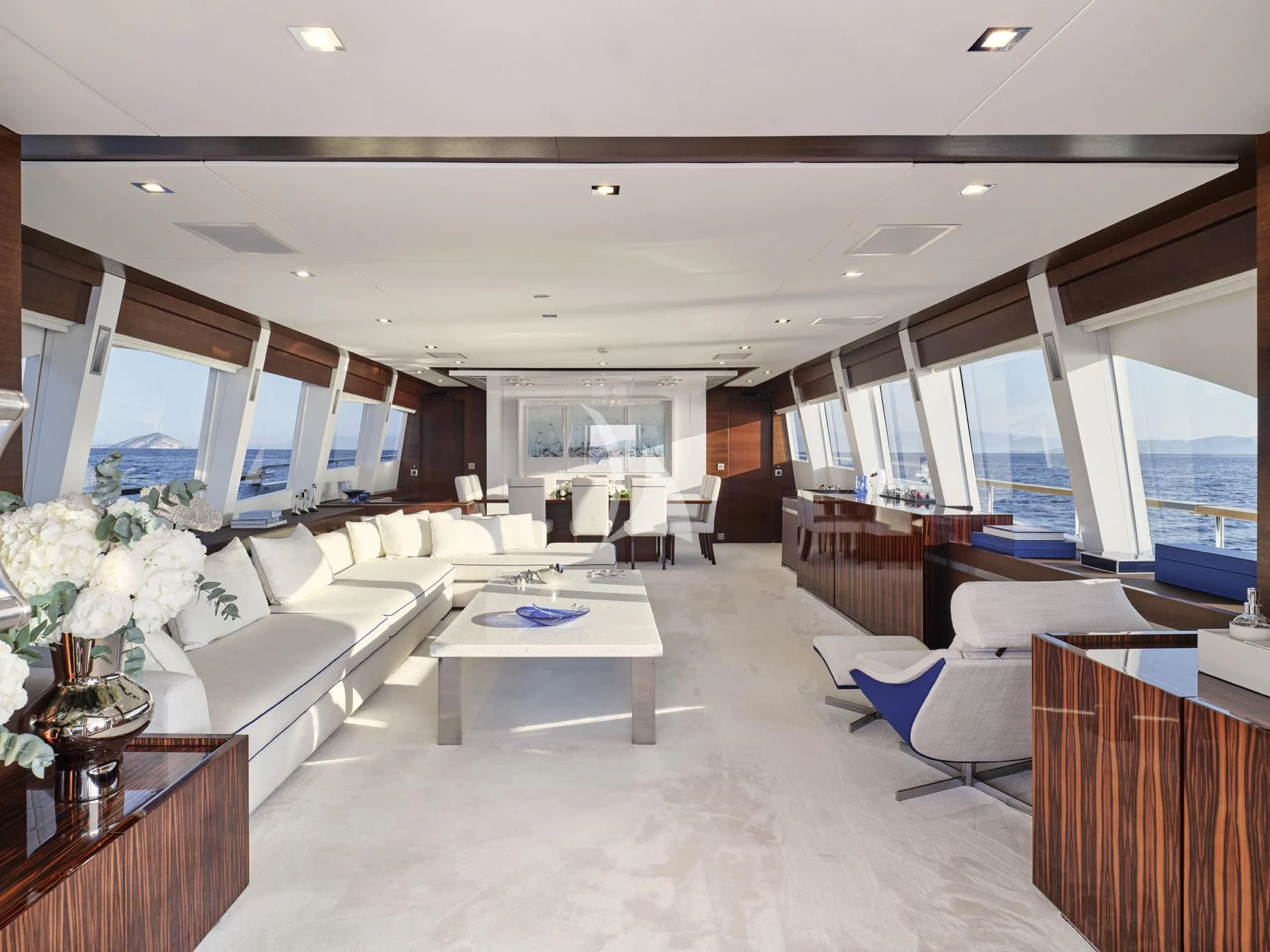 a large living room with a large window aboard HAKUNA MATATA Yacht for Charter