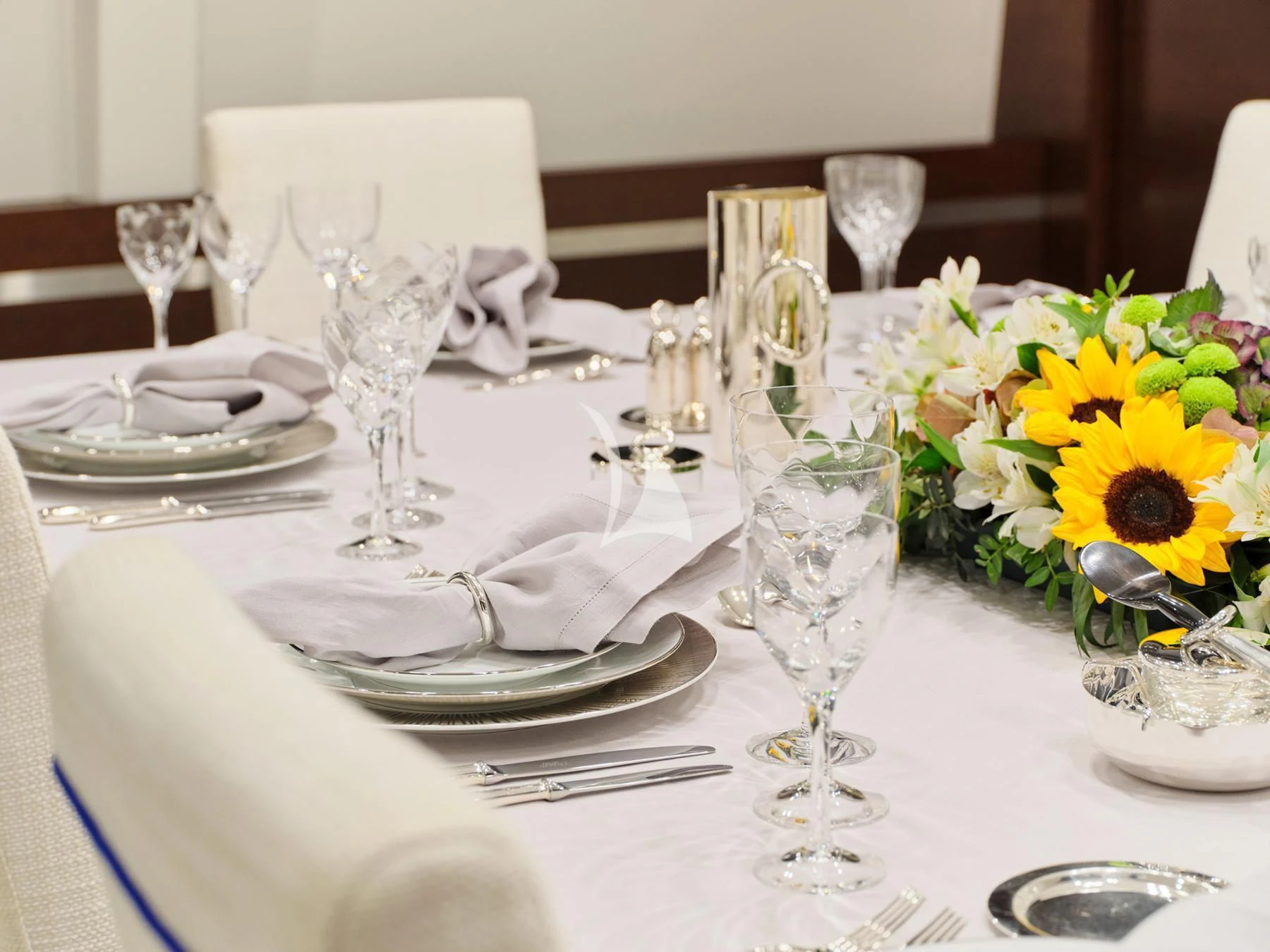 a table with plates and glasses aboard HAKUNA MATATA Yacht for Charter