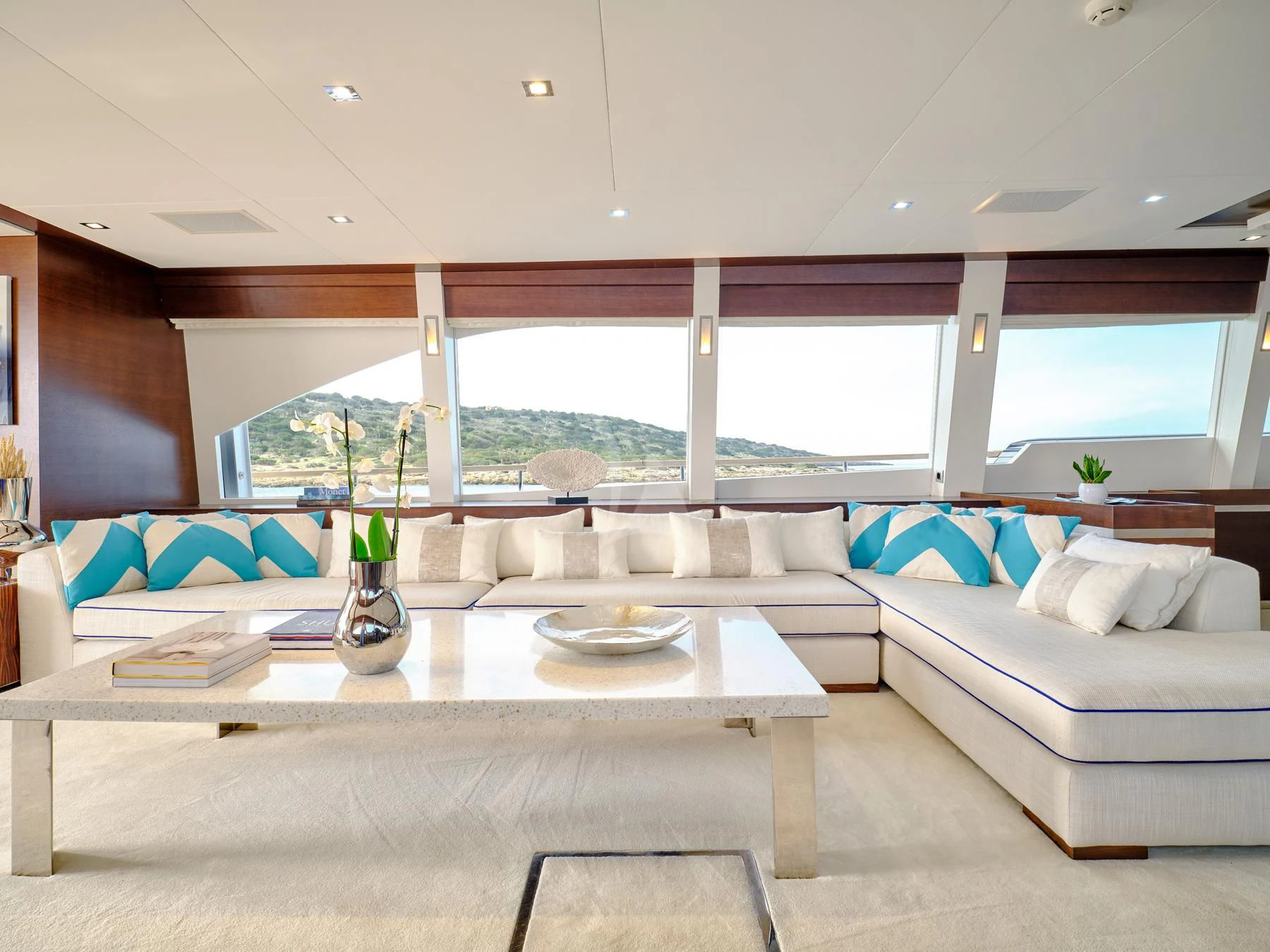 a living room with a large window aboard HAKUNA MATATA Yacht for Charter