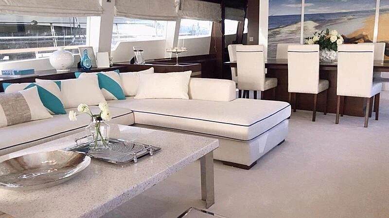 a living room with a white couch and a table aboard HAKUNA MATATA Yacht for Charter