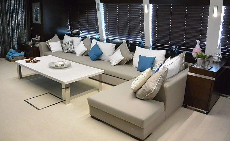 a room with a couch and a table aboard HAKUNA MATATA Yacht for Charter
