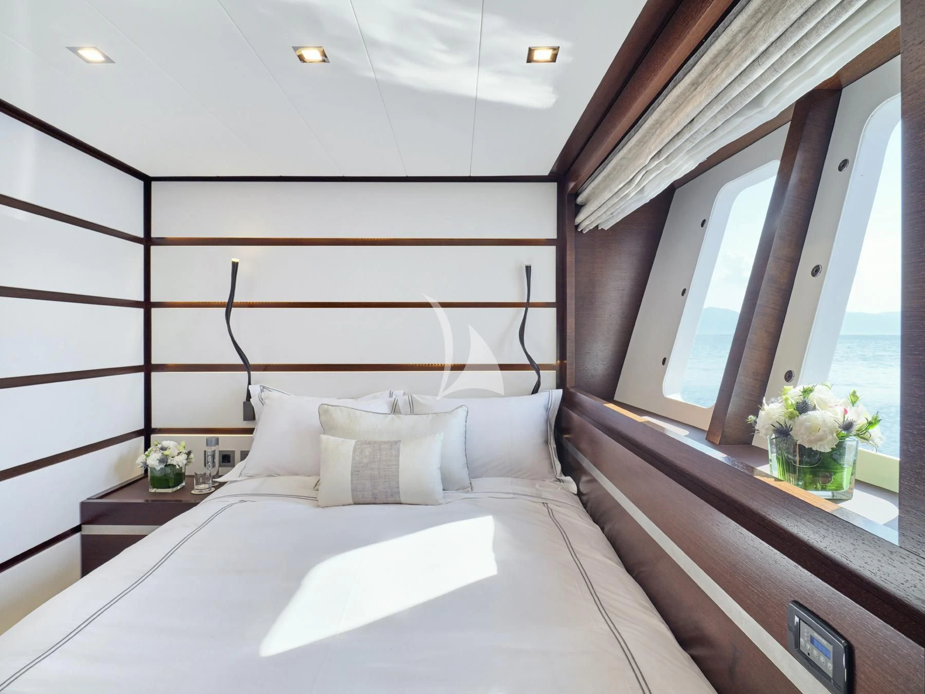 a bed with white sheets aboard HAKUNA MATATA Yacht for Charter