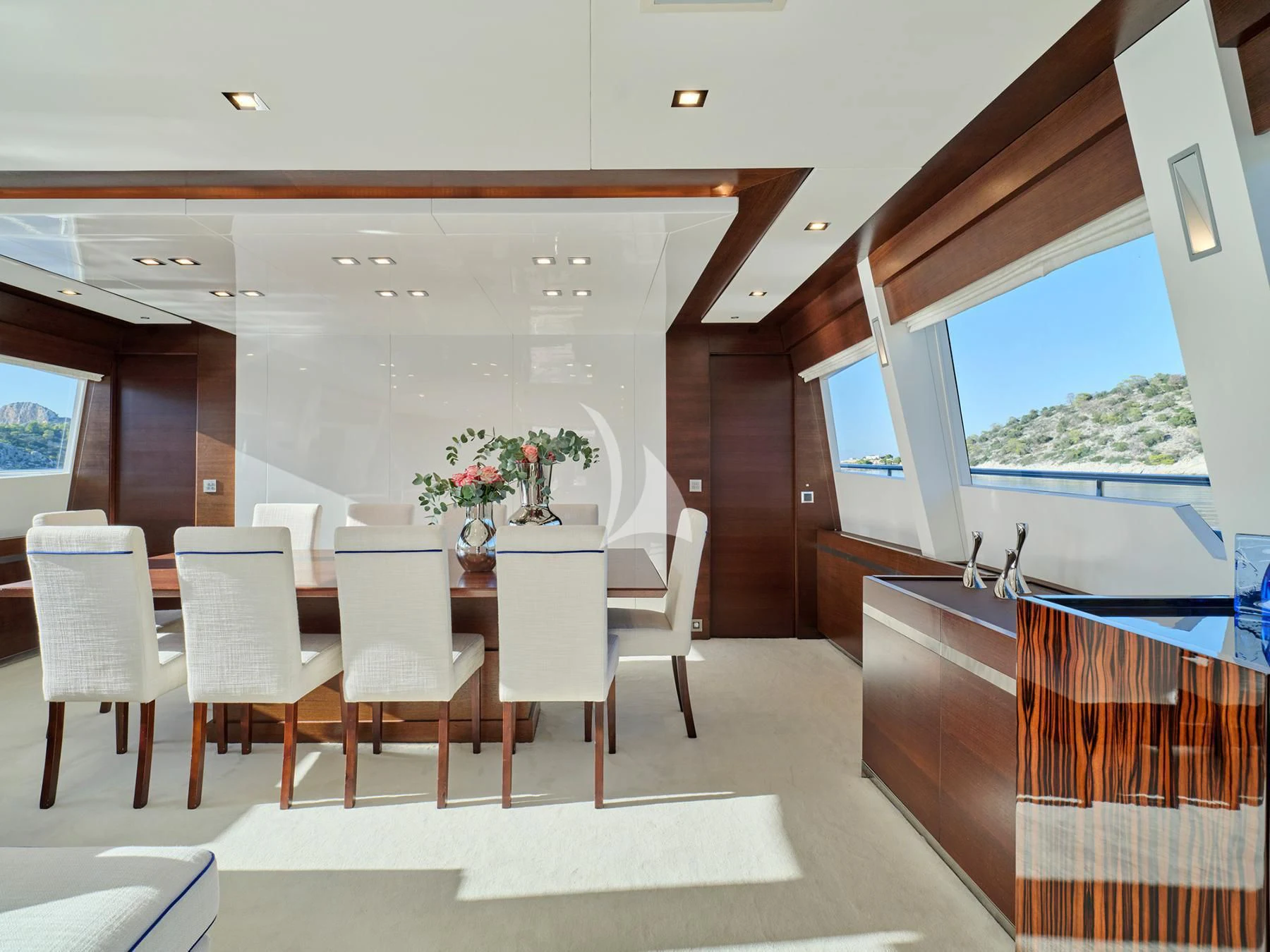 a room with tables and chairs aboard HAKUNA MATATA Yacht for Charter