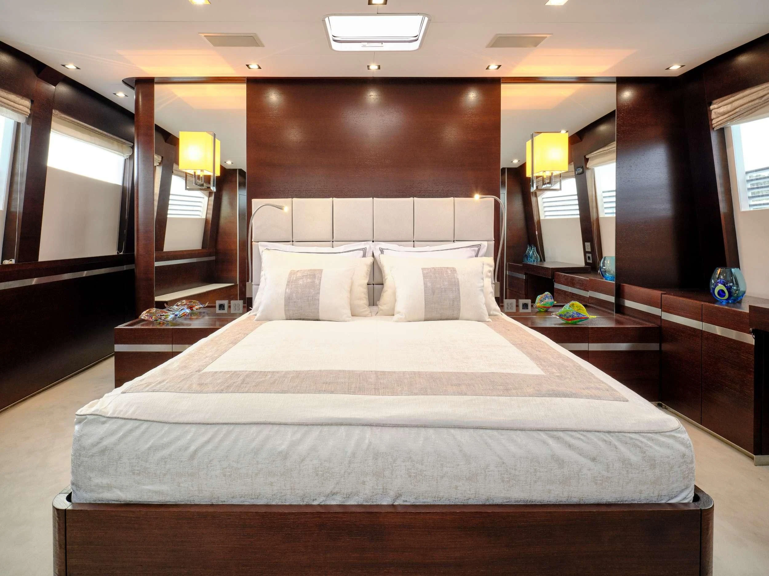 a bed with white sheets aboard HAKUNA MATATA Yacht for Charter