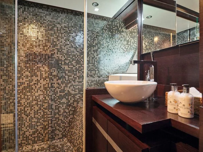 a bathroom with a sink and a mirror aboard HAKUNA MATATA Yacht for Charter