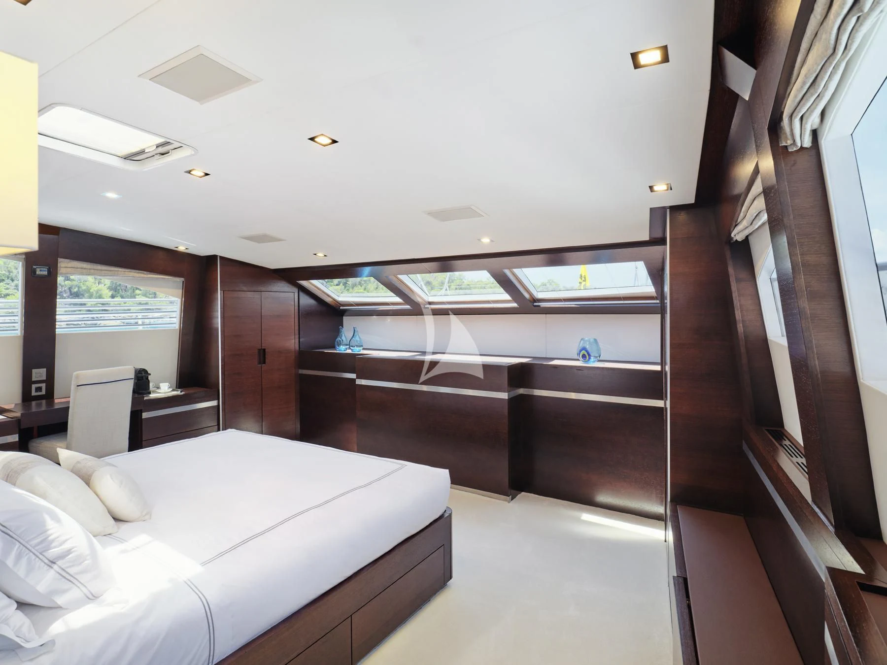 a room with a bed and a window aboard HAKUNA MATATA Yacht for Charter