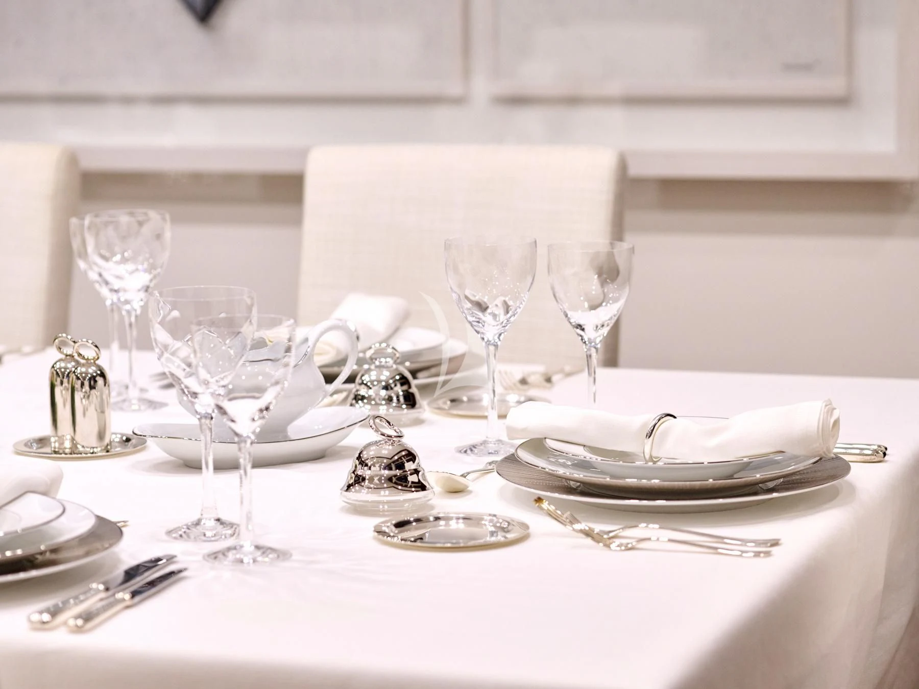a table with plates and silverware aboard HAKUNA MATATA Yacht for Charter