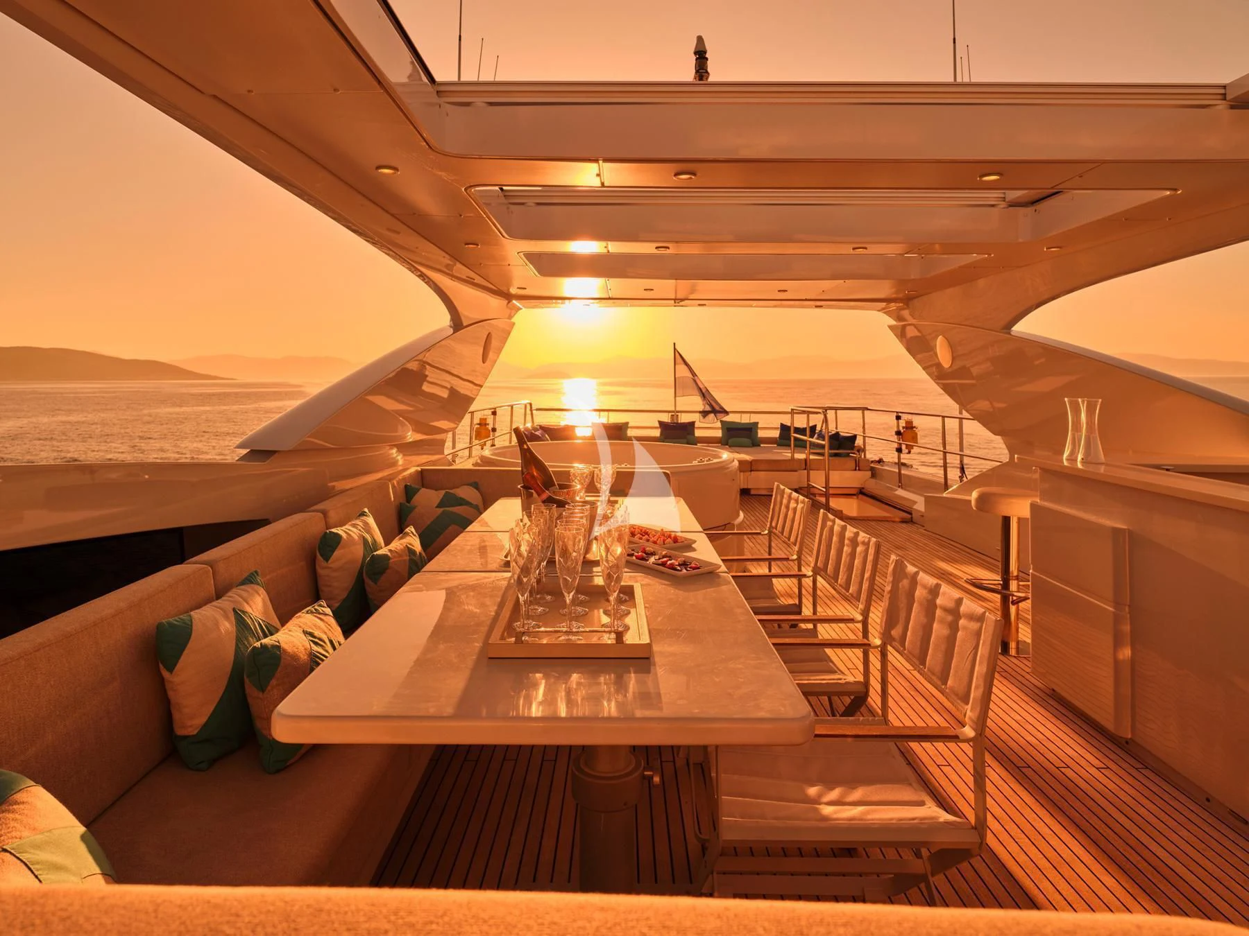 a table with chairs and a glass on it aboard HAKUNA MATATA Yacht for Charter