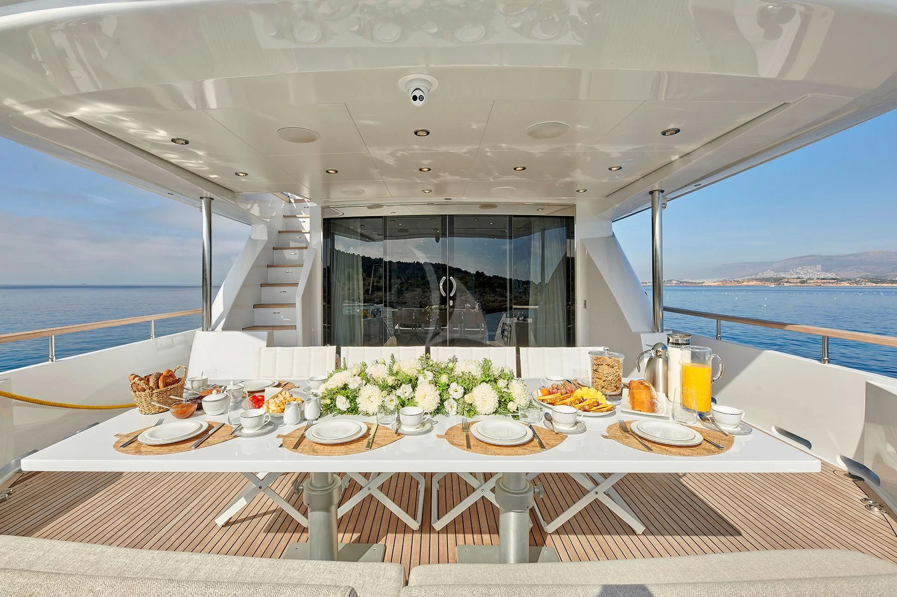 a table with plates and food on it aboard HAKUNA MATATA Yacht for Charter