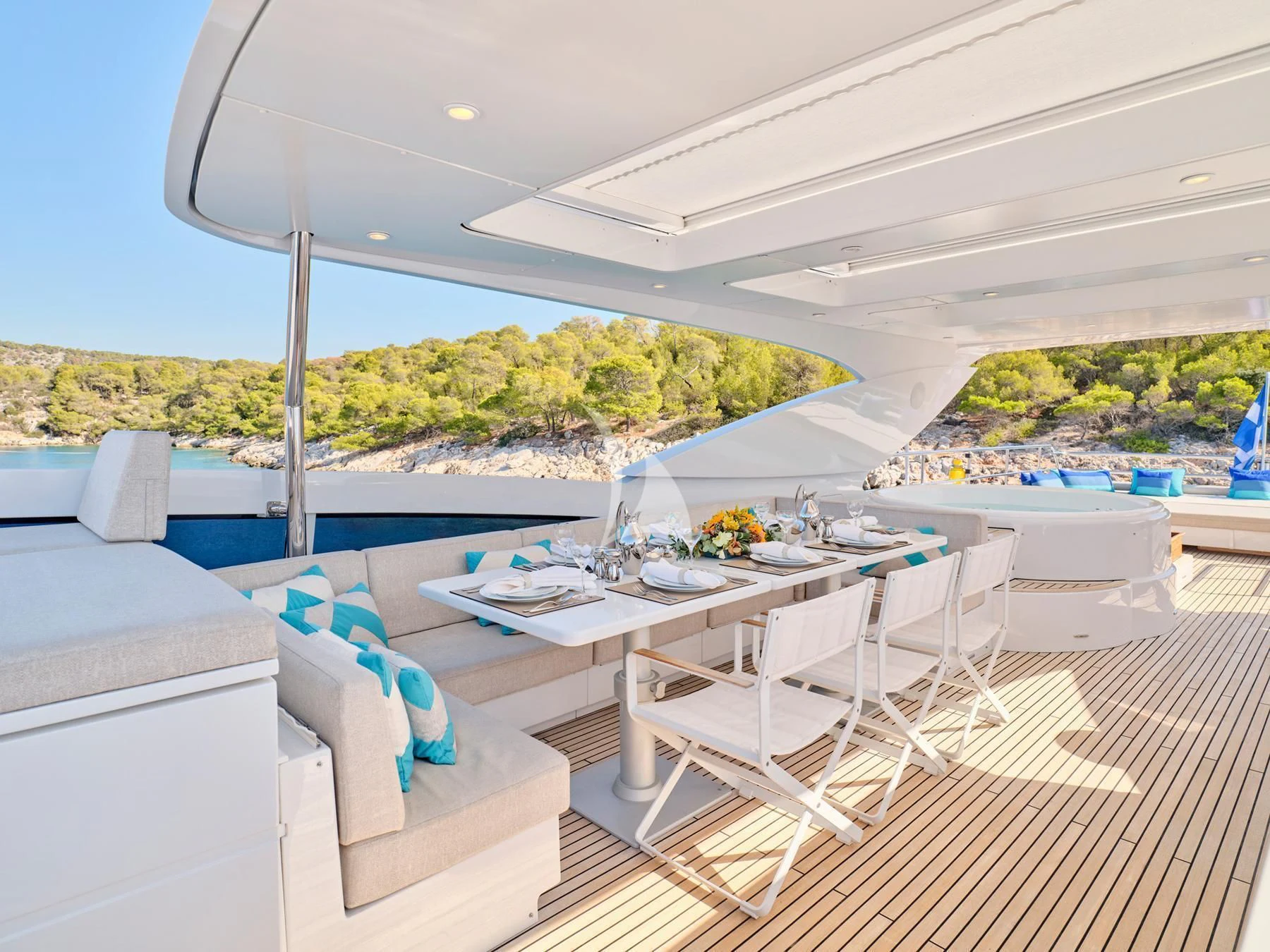 a patio with a table and chairs aboard HAKUNA MATATA Yacht for Charter