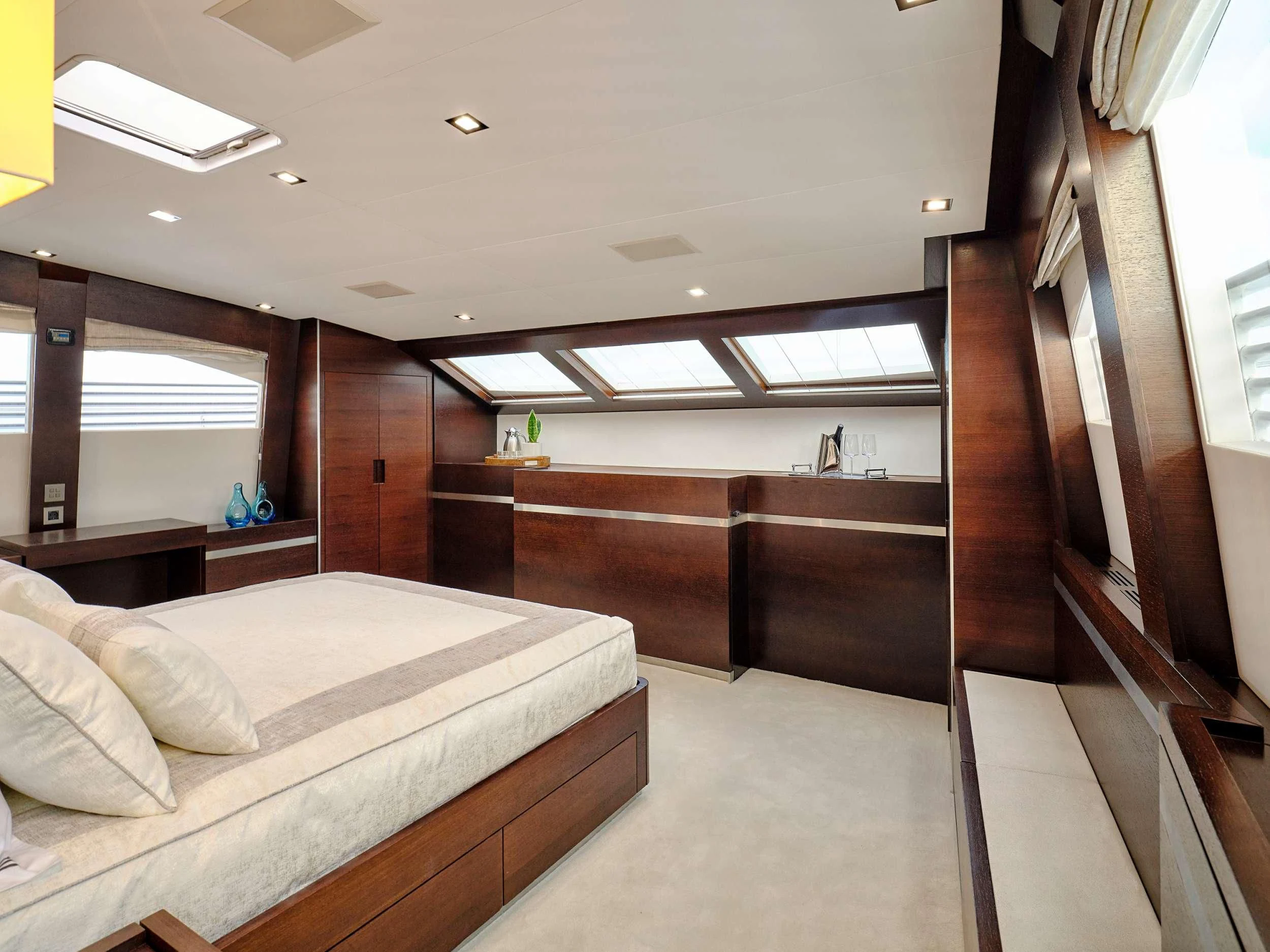 a room with a bed and a window aboard HAKUNA MATATA Yacht for Charter