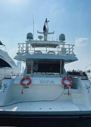 a large white boat with a statue on top aboard SOFIA Yacht for Sale