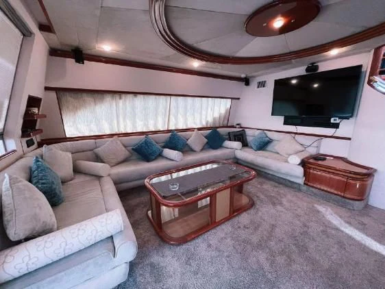 a living room with a couch and a television aboard SOFIA Yacht for Sale