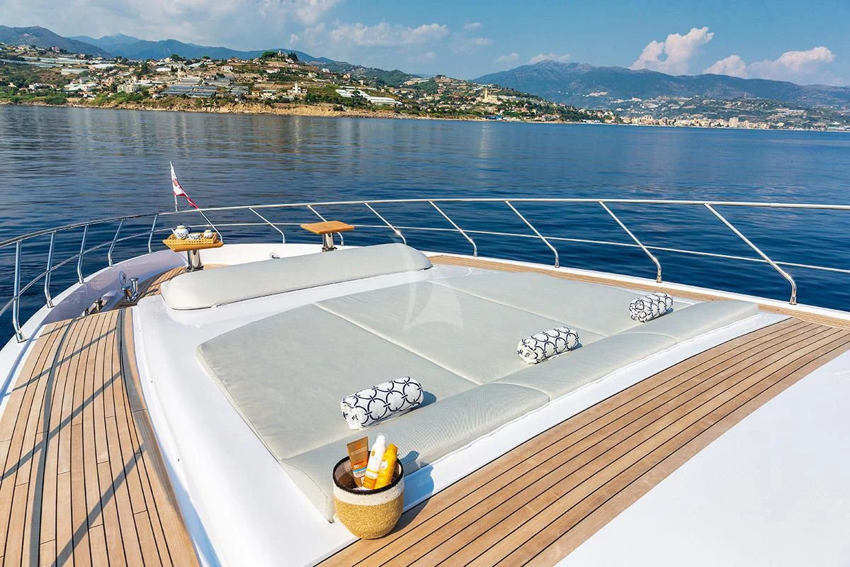 a deck with a railing and a body of water and land in the background aboard ANGIOLA Yacht for Sale