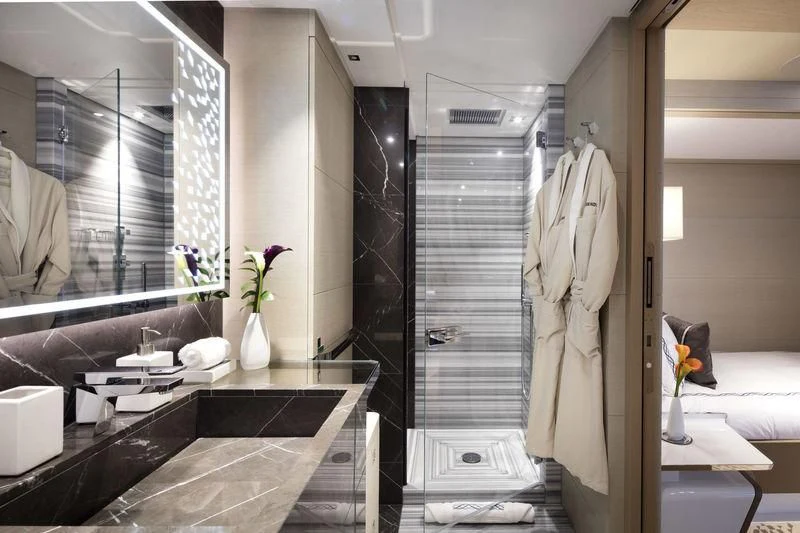 a bathroom with a glass shower aboard ARTISA Yacht for Sale