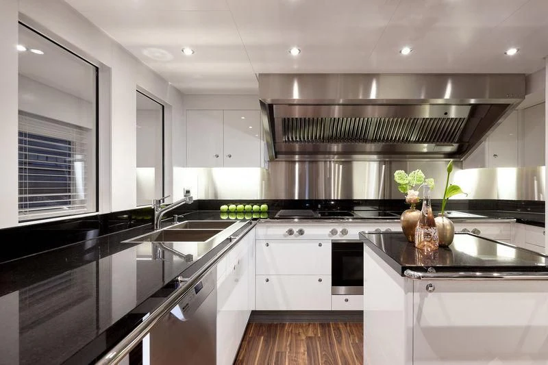 a kitchen with white cabinets aboard ARTISA Yacht for Sale