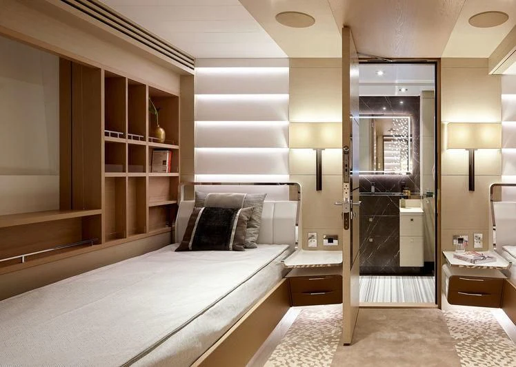 a bedroom with a bed and a desk aboard ARTISA Yacht for Sale