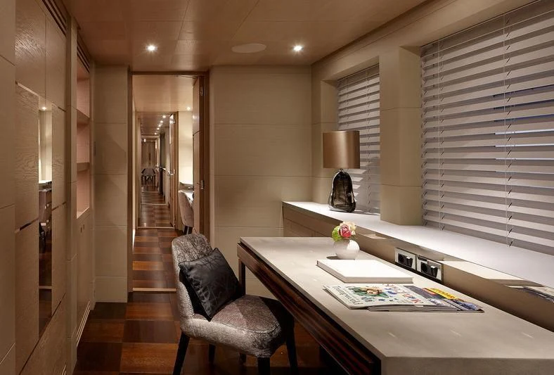 a room with a table and a chair aboard ARTISA Yacht for Sale