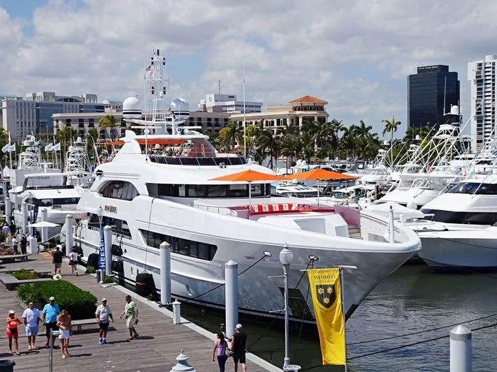 a large white boat docked at a pier with people walking around aboard ARTISA Yacht for Sale