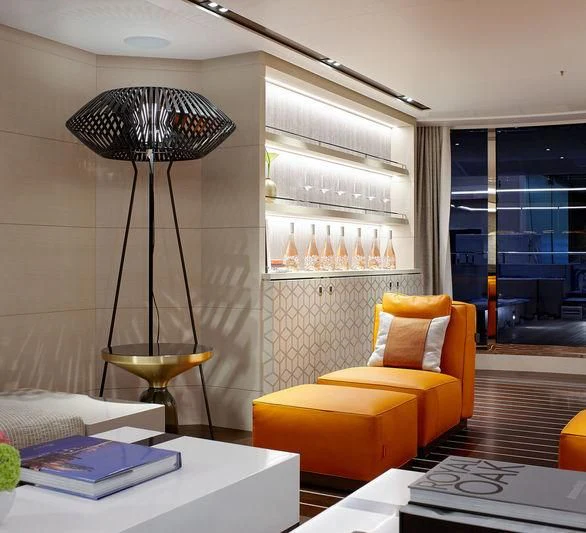 a room with a lamp and a table with books on it aboard ARTISA Yacht for Sale