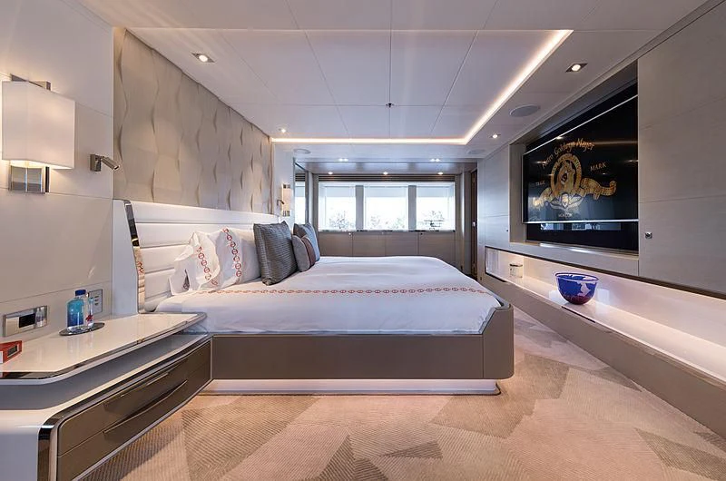 a room with a bed and a desk aboard ARTISA Yacht for Sale