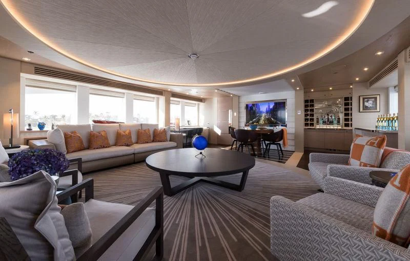a living room with a table and couches aboard ARTISA Yacht for Sale
