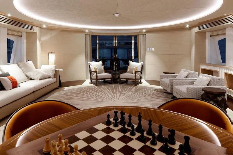 a large room with a large bed and a table aboard ARTISA Yacht for Sale