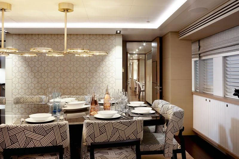 a dining room with a table and chairs aboard ARTISA Yacht for Sale