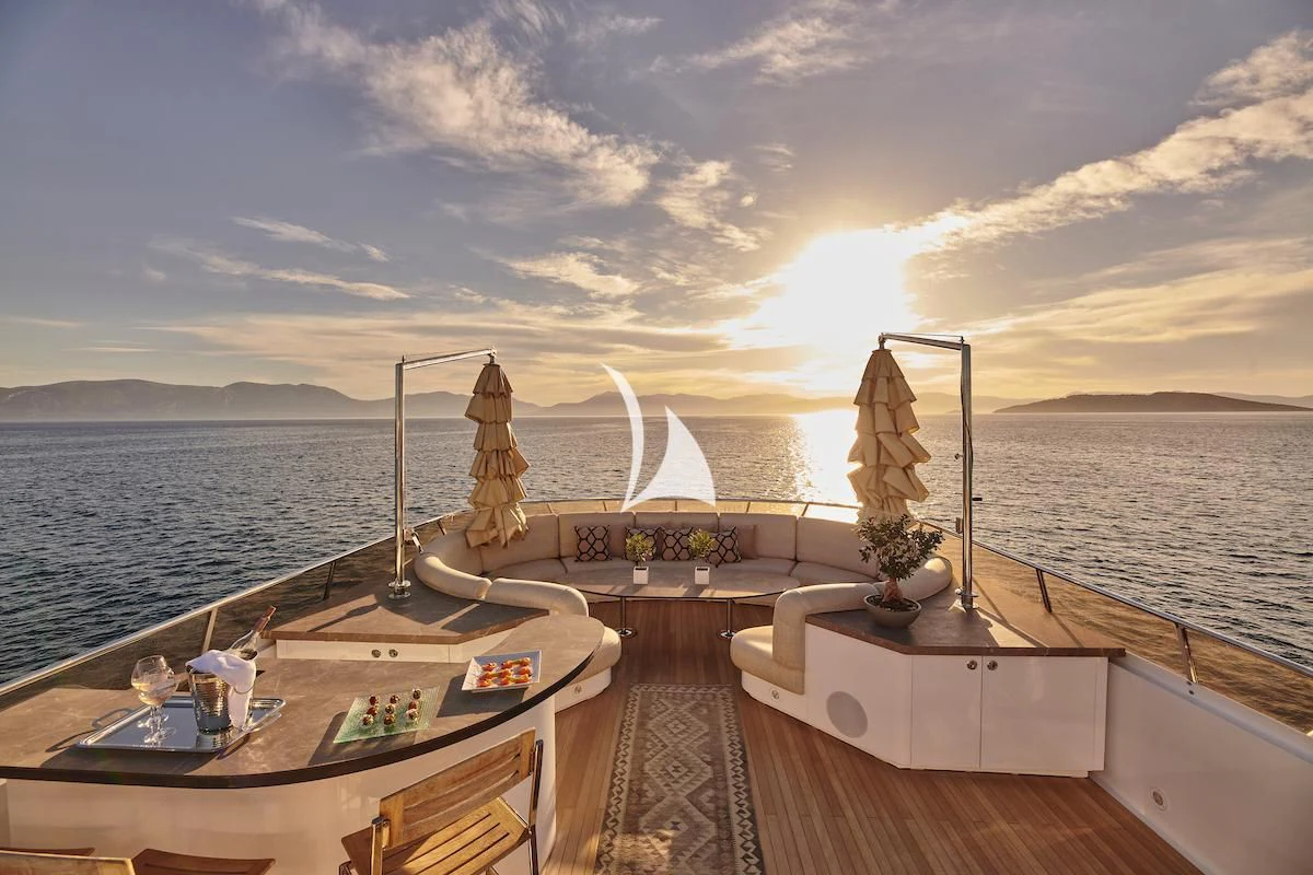 a deck with a large body of water and a large ship in the distance aboard PROMETHEUS I Yacht for Charter